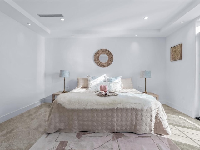 bedroom with a raised ceiling