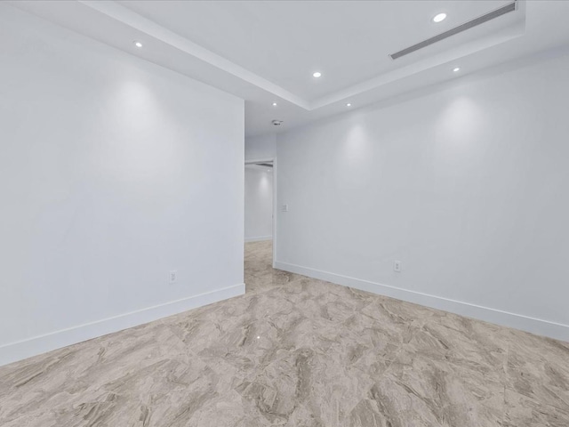 spare room featuring a raised ceiling