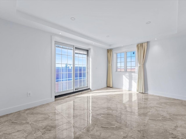 empty room featuring a raised ceiling