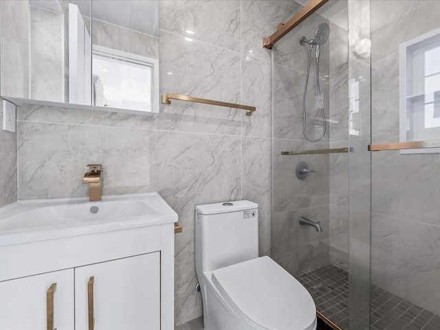 bathroom with vanity, toilet, and a shower with door