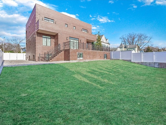 rear view of house with a lawn