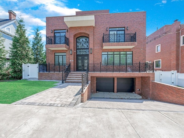 233-12 Bay St, Douglaston, NY 11363 - view of front of property with brick siding, french doors, a balcony, and concrete driveway