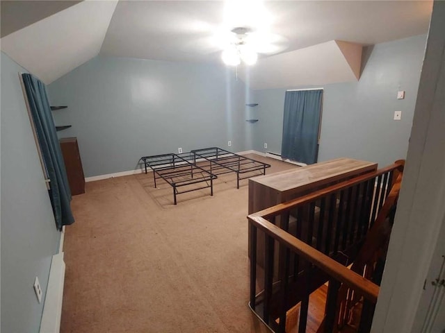 bedroom featuring baseboard heating, carpet floors, and lofted ceiling