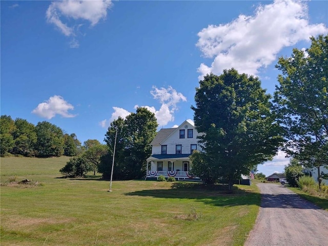 view of front facade with covered porch and a front lawn