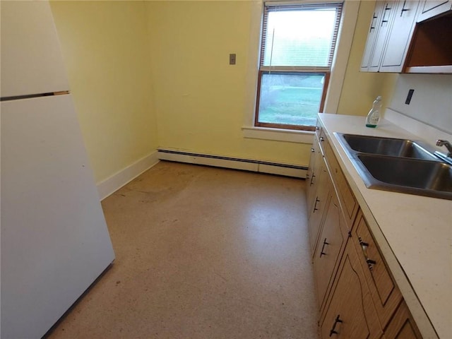 kitchen featuring baseboard heating and sink