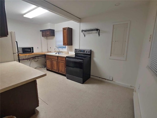 kitchen with sink, electric range, white fridge, and electric panel