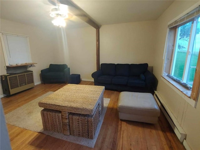 living room with radiator heating unit, hardwood / wood-style flooring, a baseboard radiator, and ceiling fan