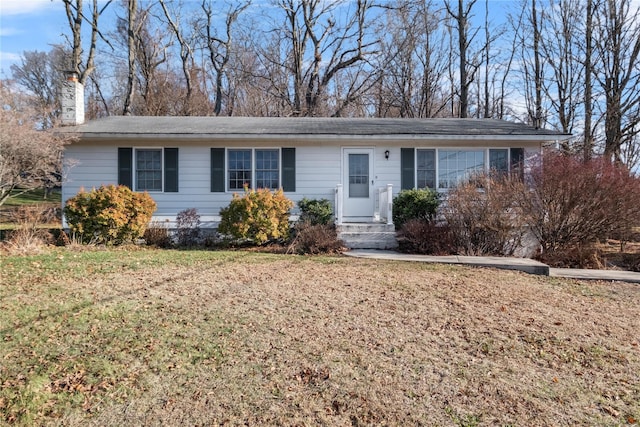 ranch-style home with a front lawn