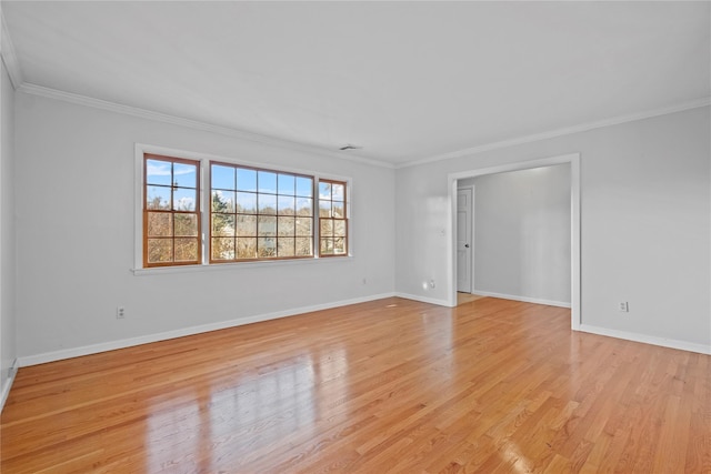 empty room with light wood-type flooring and ornamental molding