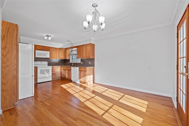 kitchen with white appliances, an inviting chandelier, light hardwood / wood-style flooring, decorative backsplash, and decorative light fixtures