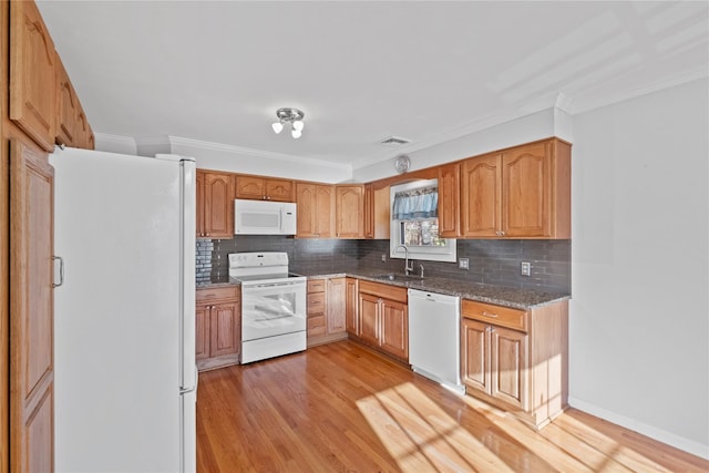 kitchen featuring white appliances, sink, ornamental molding, tasteful backsplash, and light hardwood / wood-style floors