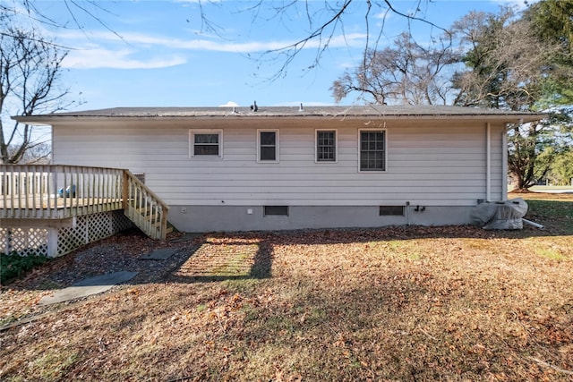 rear view of property with a wooden deck