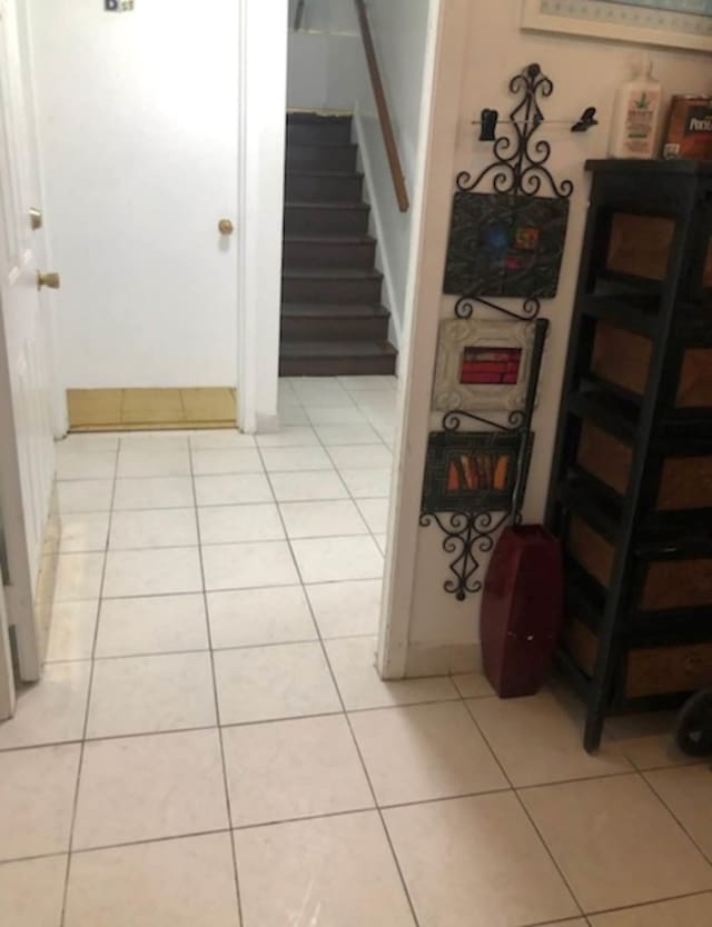 stairway with tile patterned floors