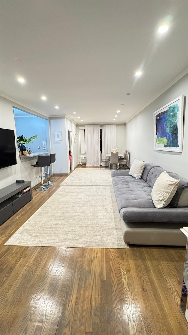 living room with hardwood / wood-style flooring and ornamental molding