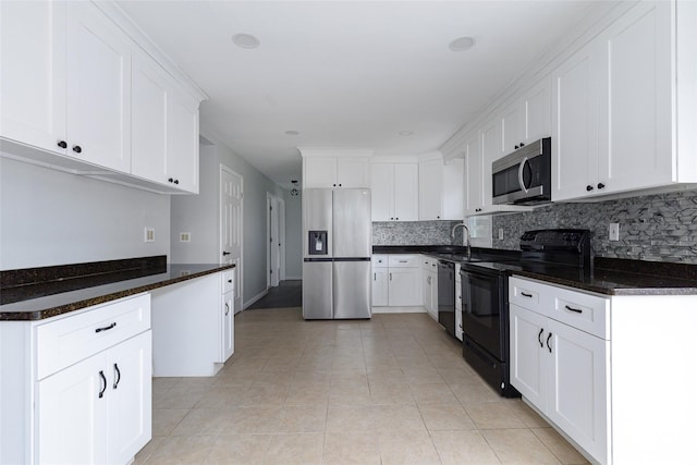 kitchen with tasteful backsplash, white cabinetry, and black appliances