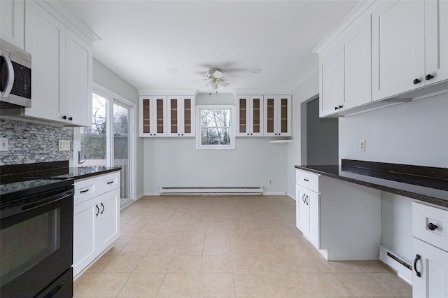 kitchen with black range with electric stovetop, ceiling fan, a baseboard radiator, dark stone countertops, and white cabinetry