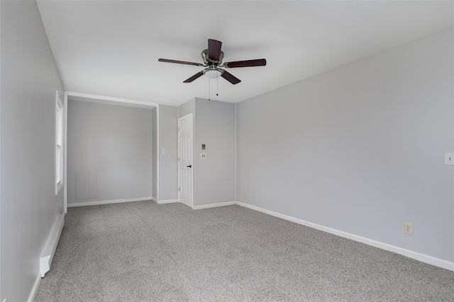 empty room with ceiling fan and carpet floors