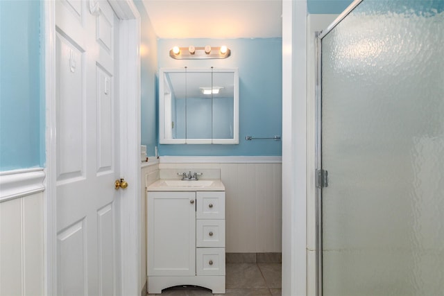 bathroom with vanity, tile patterned floors, and a shower with shower door