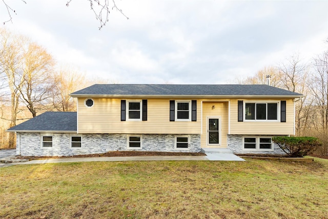 raised ranch featuring a front lawn