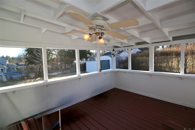 unfurnished sunroom featuring ceiling fan and a wealth of natural light