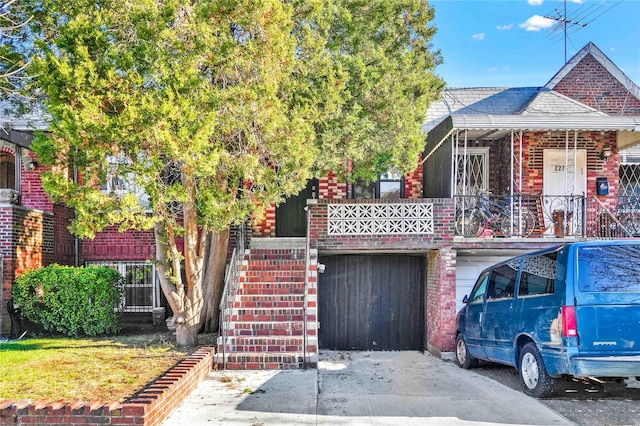 2273 E 27th St, Brooklyn, NY 11229 - view of front of property with brick siding, stairs, a garage, and a shingled roof