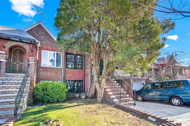 2273 E 27th St, Brooklyn, NY 11229 - view of front of home with brick siding, a garage, a front yard, and stairs
