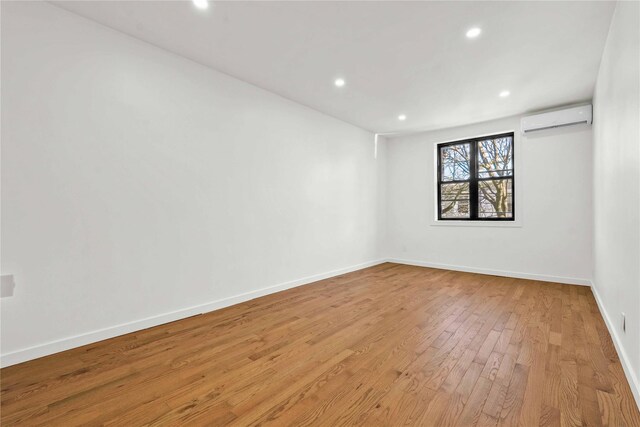 2273 E 27th St, Brooklyn, NY 11229 - spare room with a wall mounted AC, light wood finished floors, and recessed lighting