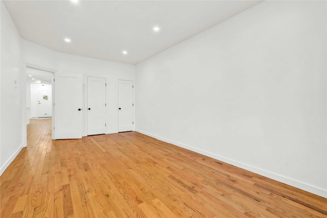 2273 E 27th St, Brooklyn, NY 11229 - unfurnished bedroom with light wood-style flooring, recessed lighting, and multiple closets