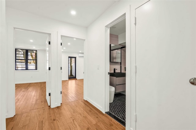 2273 E 27th St, Brooklyn, NY 11229 - hallway featuring light wood finished floors, recessed lighting, and a wall unit AC