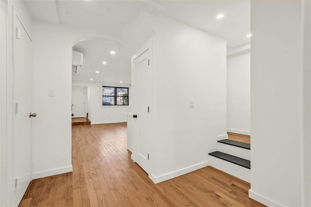 2273 E 27th St, Brooklyn, NY 11229 - corridor with arched walkways, light wood-type flooring, recessed lighting, an AC wall unit, and stairs