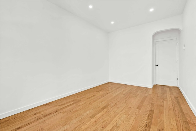 empty room with light hardwood / wood-style flooring