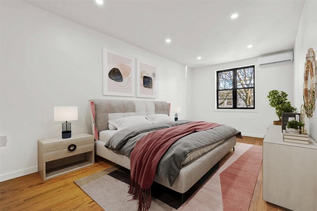 2273 E 27th St, Brooklyn, NY 11229 - bedroom featuring a wall mounted AC, light wood-style flooring, and recessed lighting