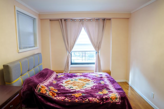 bedroom featuring ornamental molding and wood-type flooring