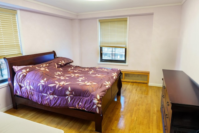 bedroom featuring light hardwood / wood-style floors and ornamental molding