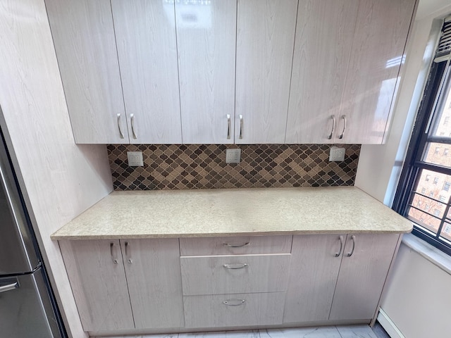 kitchen with refrigerator and decorative backsplash