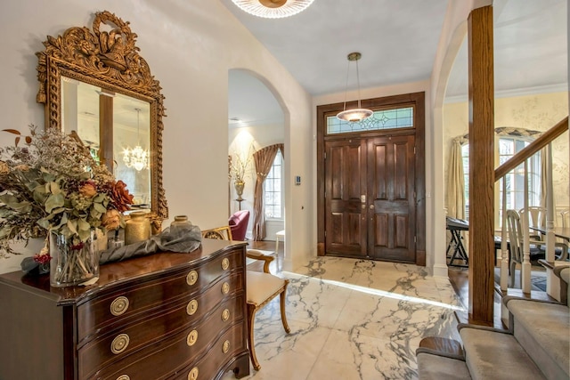 foyer featuring ornamental molding