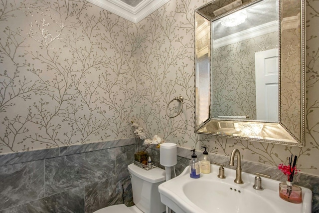 bathroom with toilet, sink, and crown molding