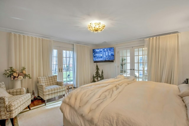 bedroom featuring multiple windows, crown molding, and french doors