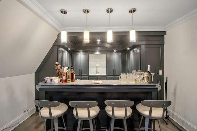 bar with crown molding, sink, wood-type flooring, and decorative light fixtures