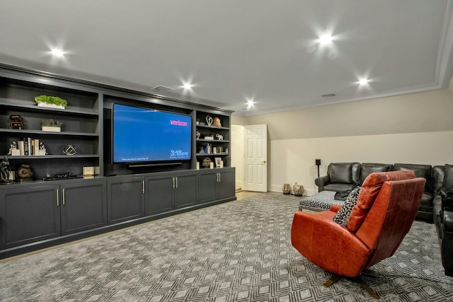 home theater room with built in shelves and carpet floors