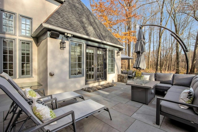 view of patio / terrace with an outdoor living space with a fire pit