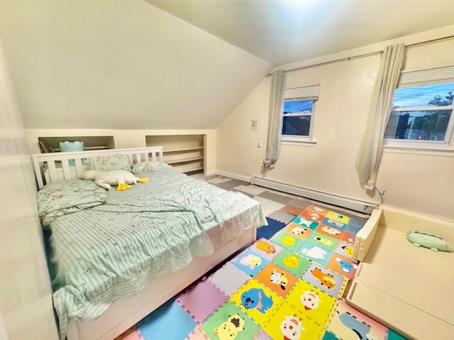 bedroom featuring lofted ceiling and baseboard heating