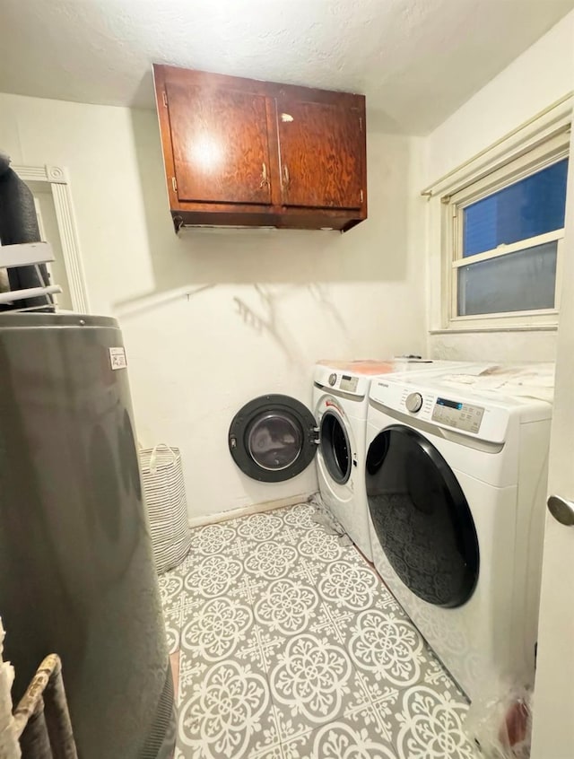 laundry room with washer and clothes dryer and cabinets