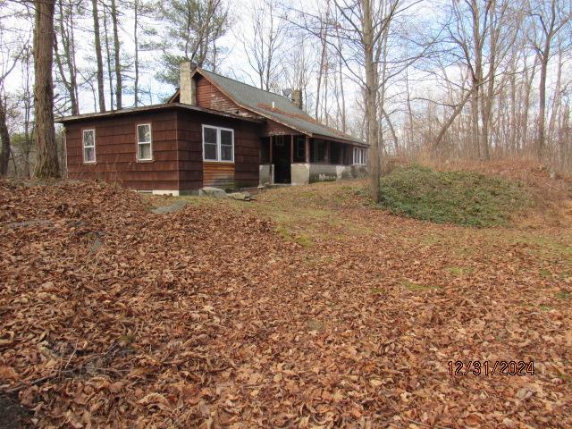 view of home's exterior with a sunroom