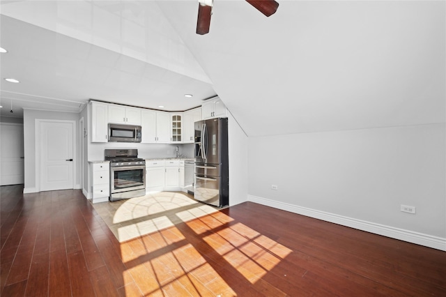 kitchen with white cabinetry, hardwood / wood-style floors, lofted ceiling, and appliances with stainless steel finishes