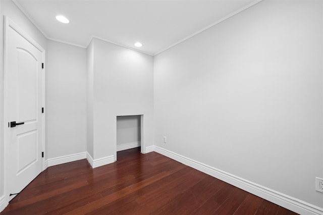 unfurnished room featuring dark hardwood / wood-style flooring and ornamental molding