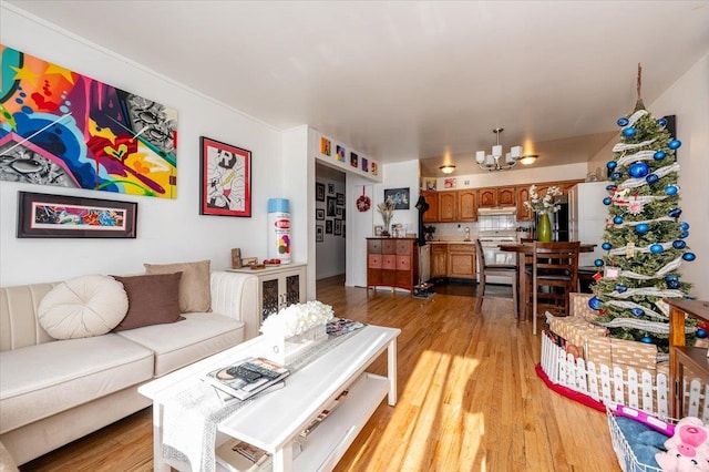 living room featuring light hardwood / wood-style floors and an inviting chandelier