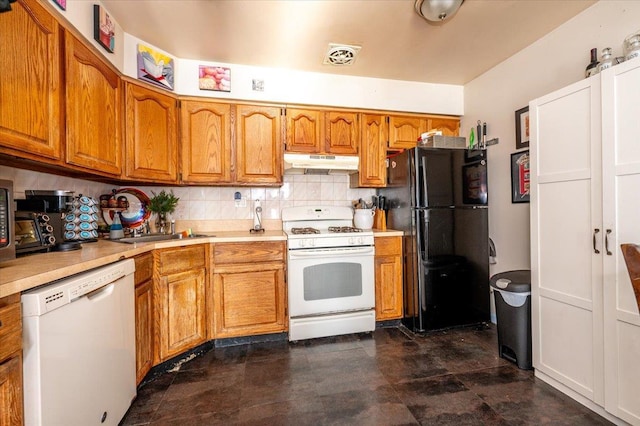 kitchen featuring sink, white appliances, and backsplash