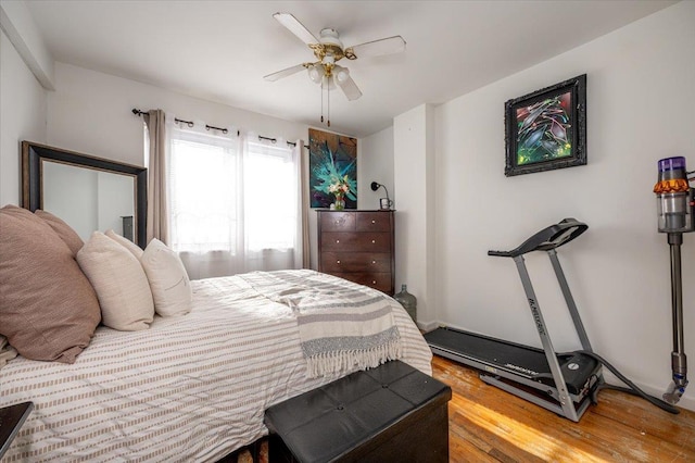 bedroom with ceiling fan and hardwood / wood-style flooring