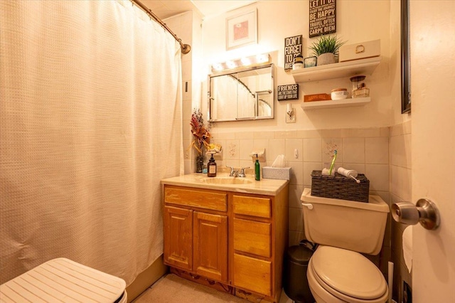 bathroom with a shower with shower curtain, vanity, toilet, and tile walls